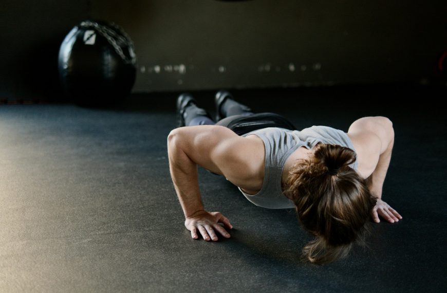 woman doing push-ups on the gym floor