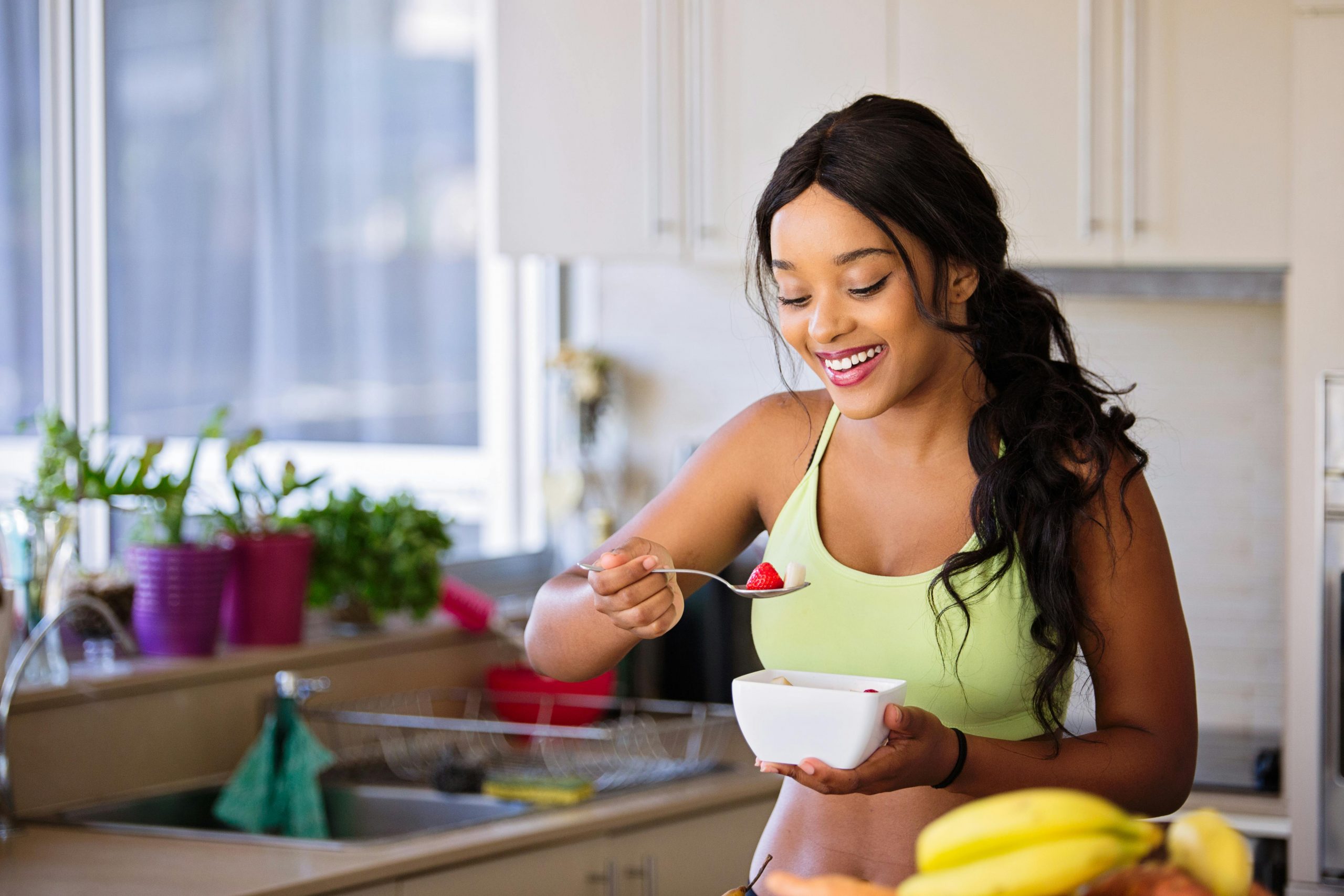 woman in workout clothing enjoying a nutritious meal